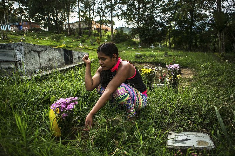 Melida, who was abducted by Colombian rebels at age 9, visits the grave of her cousin, who also was forced to serve and wound up taking her own life. “There are times when I think about returning to the guerrillas because this life is hard here,” she says. 