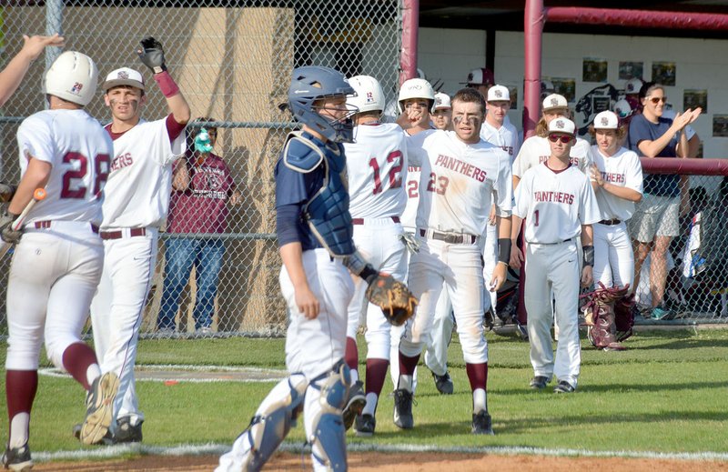 Graham Thomas/Siloam Sunday Siloam Springs baseball players celebrate after Nate Free, 28, and Zac Bolstad, 12, scored during the third inning to give the Panthers a 2-0 lead against Greenwood on Thursday. Siloam Springs won the game 4-2.