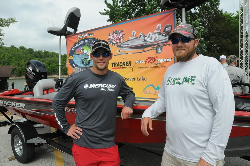 Mike Hubbard (left) and Justin McClelland, both of Bella Vista, won the Rogers-Lowell Area Chamber of Commerce Buddy Bass Tournament held Saturday at Beaver Lake. Their prize is a new Bass Tracker boat.