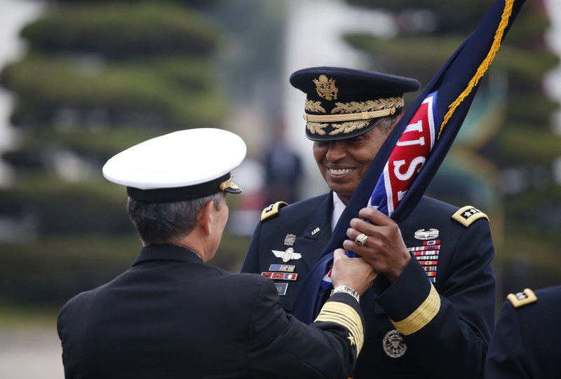 Incoming Commander General Vincent K. Brooks (right) receives the United States Forces Korea flag Saturday during a change of command ceremony for the United Nations Command, Combined Forces Command, and United States Forces Korea at the U.S. military base in Seoul. 