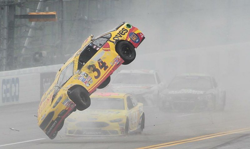 Chris Buescher’s No. 34 car goes airborne and flipped three times during a wreck in the NASCAR Sprint Cup Geico 500 on Sunday at Talladega Superspeedway in Talladega, Ala. Buescher was uninjured in the crash. Thirty-five of the 40 cars entered in the race were involved in some type of accident, and 12 were unable to finish.