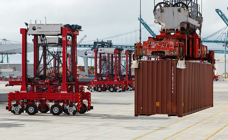 Fully automated AutoStrads pick up shipping containers to be moved at the TraPac LLC shipping terminal at the Port of Los Angeles in March.