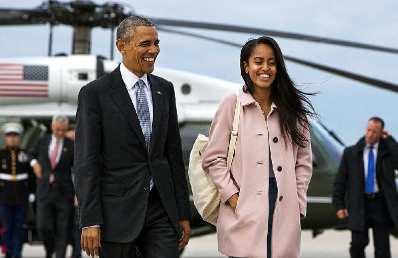 In a Thursday, April 7, 2016 file photo, President Barack Obama jokes with his daughter Malia Obama as they walk to board Air Force One from the Marine One helicopter, as they leave Chicago en route to Los Angeles.  
