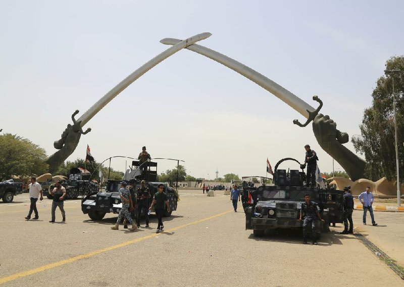 Iraqi security forces stand guard as supporters of Shiite cleric Muqtada al-Sadr leave Baghdad’s highly fortified Green Zone on Sunday.