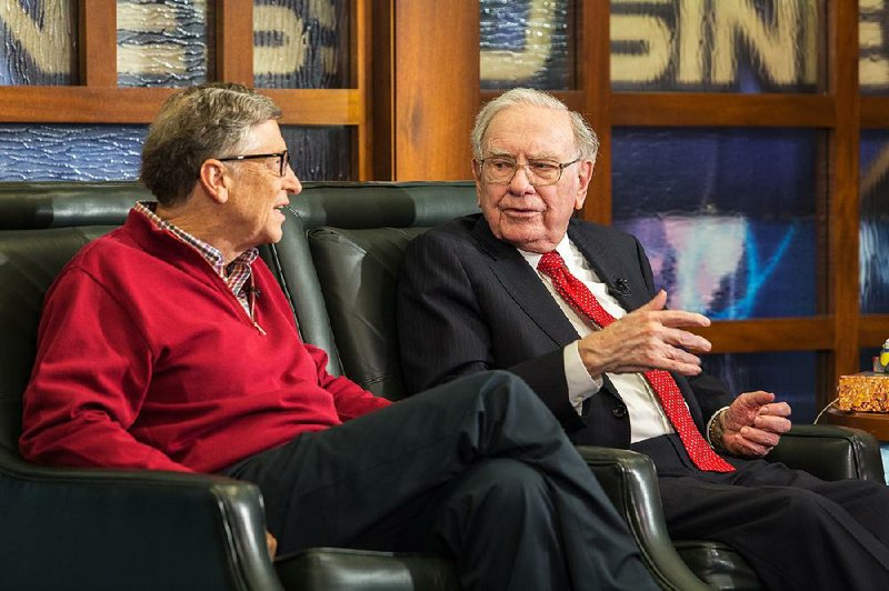 Microsoft co-founder and Berkshire board member Bill Gates (left), and Berkshire Hathaway Chairman and CEO Warren Buffett speak Monday in Omaha, Neb., during an interview for the Fox Business Network.