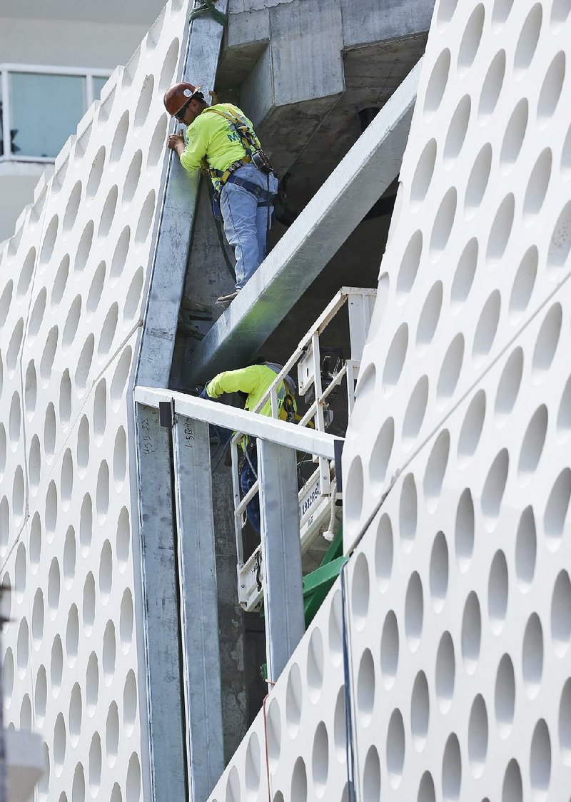 A construction crew works on a building in Miami Beach, Fla., in April. U.S. construction spending rose 0.3 percent in March after a 1 percent gain in February, the Commerce Department said Monday.