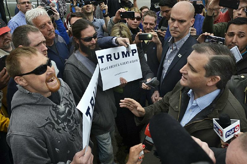 Republican presidential candidate Ted Cruz exchanges words with Donald Trump supporters Monday during a campaign visit to Marion, Ind. Cruz said of today’s Indiana primary, “This entire political process has conspired to put the state of Indiana in the position to stand up and speak the voice of sanity.”