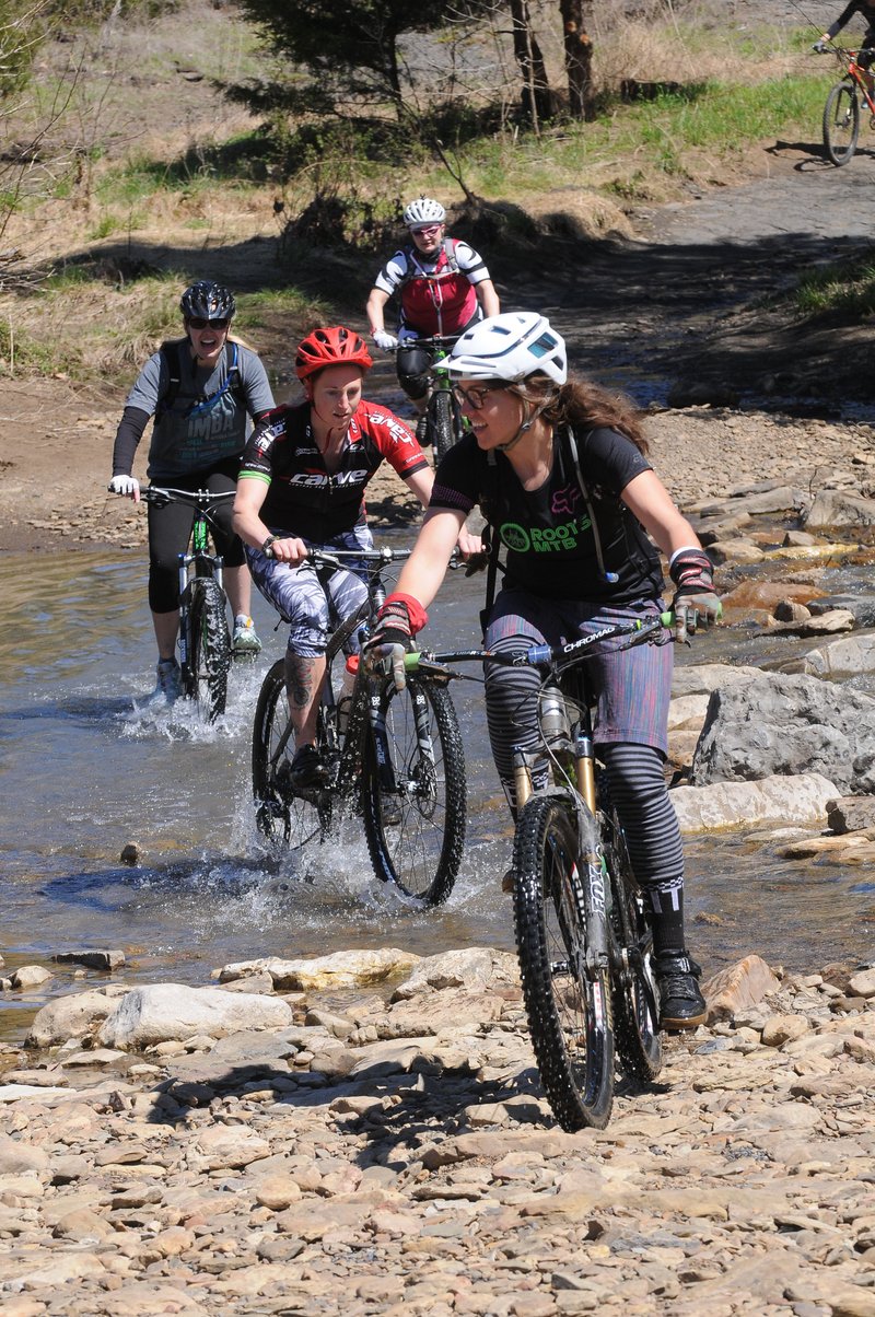 Tandie Bailey leads riders across Lee Creek during a ride on the Fossil Flats Trail at Devil’s Den State Park. The 5.5-mile route for hiking or mountain biking meanders through nature and history.