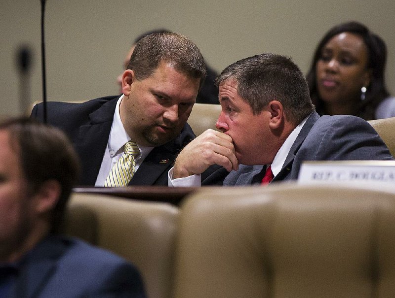 Rep. Jim Dotson (left) talks with Rep. Richard Womack after Dotson’s amendment seeking restrictions on the use of assistance to needy families was endorsed Tuesday by the Joint Budget Committee.