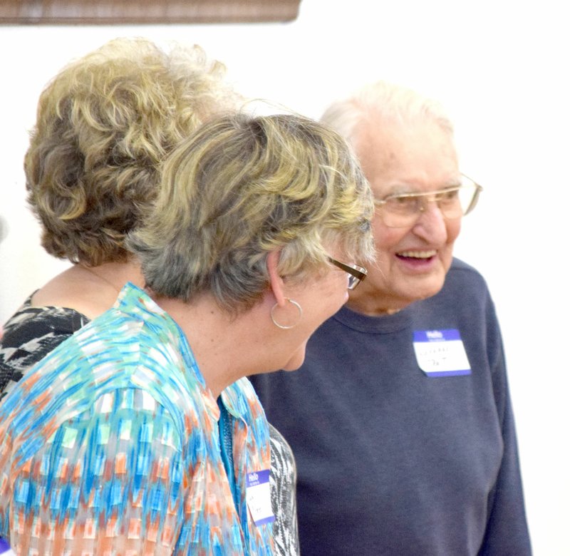 Photo by Mike Eckels Paula McGhee (center) talks to Leonard Truitt (right) during the Decatur Alumni Association&#8217;s biennial banquet held in the community room at Decatur City Hall April 23. At 98, Truitt was the oldest Decatur High School graduate at the reunion.