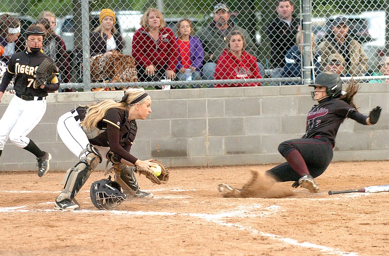 MIKE CAPSHAW ENTERPRISE LEADER Lincoln&#x2019;s Hollie Webb slides safely into home ahead of the tag by Prairie Grove catcher Savannah Stear as pitcher Laney Layman backs up the play during the Lady Wolves&#8217; 8-3 win in the 4A-1 Conference Tourney title game on Monday at Gentry.