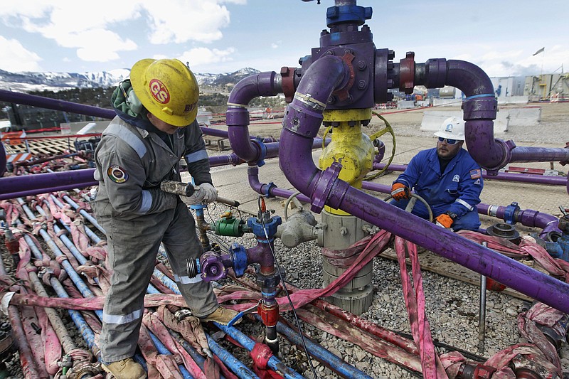 Workers tend to a well head during a hydraulic fracturing operation outside Rifle, western Colorado, in this March 29, 2013, file photo. story.lead_photo.caption