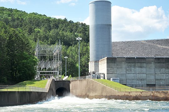 The Sentinel-Record/Mara Kuhn FLOOD CONTROL: Water churns out of the flood tunnel at Blakely Mountain Dam into Lake Hamilton on Tuesday afternoon. The tunnel was opened to supplement releases being made by hydro generation, after Lake Ouachita rose into the flood pool over the weekend.