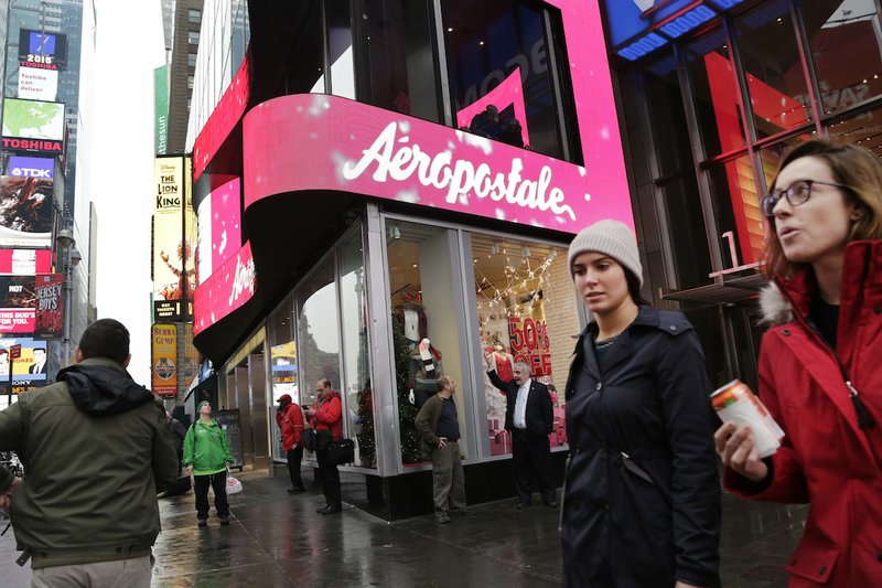 In this Wednesday, Dec. 2, 2015, file photo, women pass an Aeropostale clothing store in New York's Times Square. Aeropostale, once the vibrant epicenter of the U.S. mall scene, announced Wednesday, May 4, 2016, it is seeking Chapter 11 bankruptcy protection. 