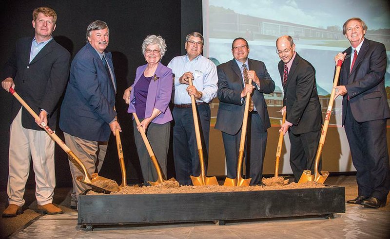 Turning dirt at the indoor groundbreaking ceremony Friday for the $13 million Workforce Training Center to be built at the University of Arkansas Community College at Morrilton are Mayor Allen Lipsmeyer, from left, Conway County Judge Jimmy Hart, Raye Pearce, Charles Penick, UACCM Board of Visitors Chairman Doug Brandon, University of Arkansas System President Donald R. Bobbitt and UACCM Chancellor Larry Davis. The $13 million facility, built by Nabholz Construction, will house technical programs that a 170-member advisory committee of industry leaders suggested.