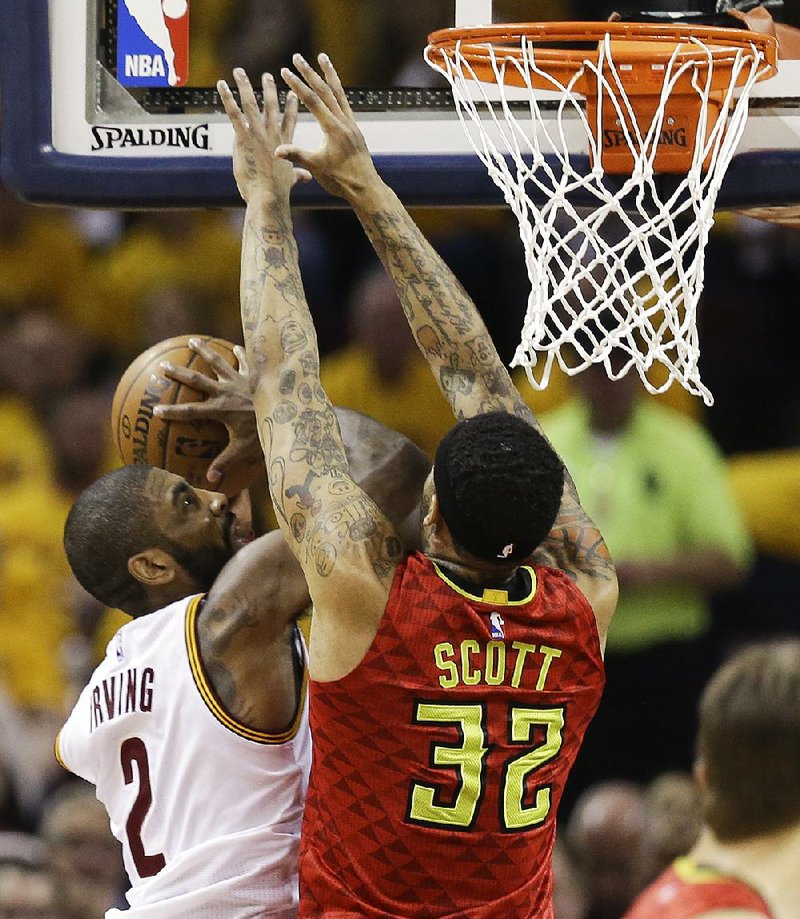 Cleveland’s Kyrie Irving (2) puts up a shot against Atlanta’s Mike Scott in the first half of the Cavaliers’ 123-98 victory, giving them a 2-0 lead in their NBA Eastern Conference semifinal series. 