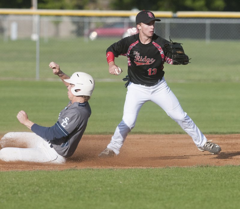 Pea Ridge’s Eric Hankins looks to make the throw to first Monday after catching Shiloh Christian’s Josh Lantzsch out at second.