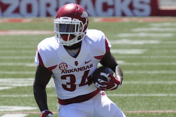 Arkansas running back Denzell Evans (34) carries the ball to the end zone Saturday, April 23, 2016, during the annual spring Red-White game in Razorback Stadium. 