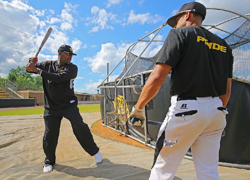 UAPB Coach Carlos James (left) talks with outfielder Jeremiah Figueroa during a recent practice. The Golden Lions are near the top of the SWAC standings despite not having the funds or scholarships available that other Division I programs have.