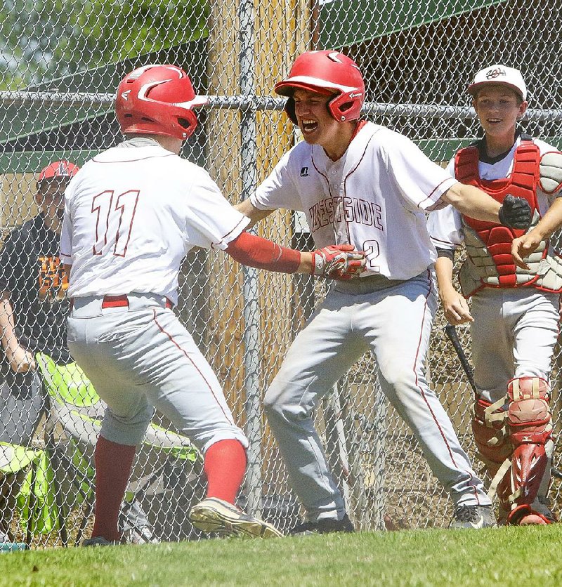 Jonesboro Westside’s Austin Tyler (11) and Luke Hart (2) celebrate after Tyler scored the tying run in the sevnth inning as the Warriors rallied for a 5-4 victory over Stuttgart on Friday at the Class 4A-East regional baseball tournament in Lonoke. 