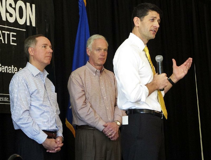 House Speaker Paul Ryan (right) joins Wisconsin’s Assembly Speaker Robin Vos (left) and Sen. Ron Johnson, R-Wis., at a campaign rally Thursday for Johnson in Burlington, Wis.