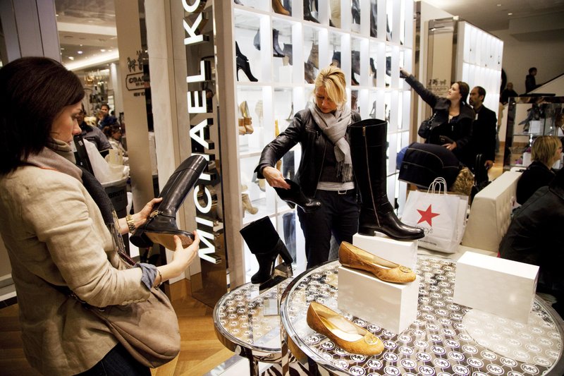 In this Oct. 12, 2012 file photo, women shop in the Michael Kors section of Macy's shoe department in New York. The International Anti-Counterfeiting Coalition's decision to welcome Chinese e-commerce giant Alibaba as a new member - and allow founder Jack Ma to make the keynote speech at its May 2016 conference - so incensed the U.S. luxury retailer Michael Kors that it severed its longstanding connection with the Washington-based industry group. 
