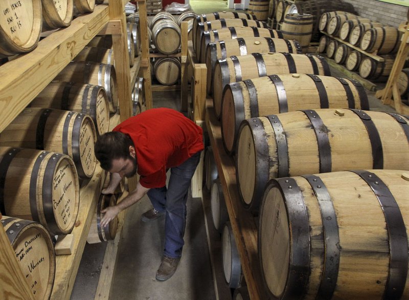 Owen Martin, a lead distiller at Rock Town Distillery, racks barrels of bourbon whiskey to age for at least a year before removing them for bottling. The Little Rock distillery filled it's 500th barrel this week since the company began production in 2010.