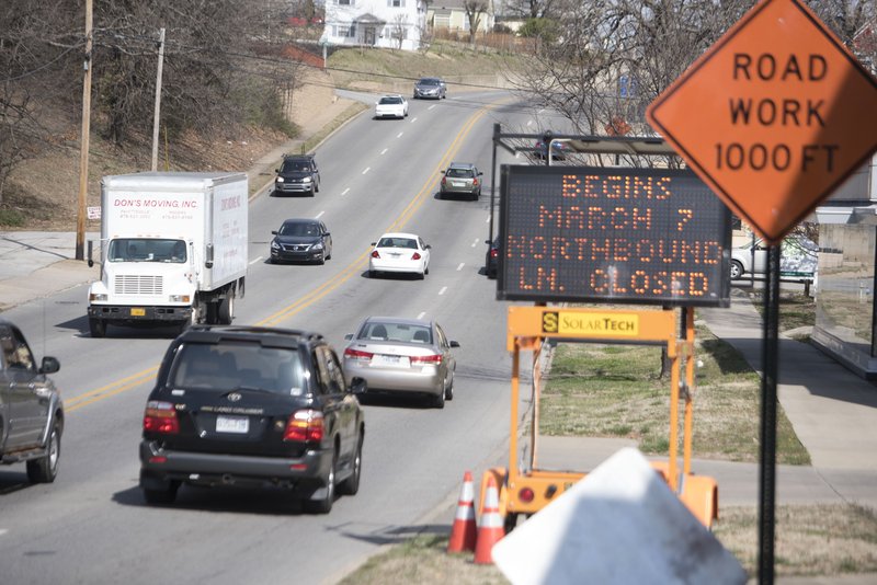 Signs warn drivers about upcoming construction on College Ave. Sunday Mar. 6, 2016. Fayetteville is starting a construction project on the east side of College Avenue to improve and widen the sidewalk and do other work between North and Maple streets. 
