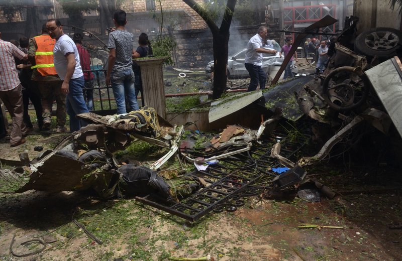 In this photo released by the Syrian official news agency SANA, Syrian citizens and firefighters gather at the scene where one of rockets hit the Dubeet hospital in the central neighborhood of Muhafaza in Aleppo, Syria, Tuesday, May 3, 2016. Shells and mortar rounds are raining down on every neighborhood Aleppo,&quot; said Aleppo-based health official Mohammad Hazouri, speaking from Al-Razi hospital. 