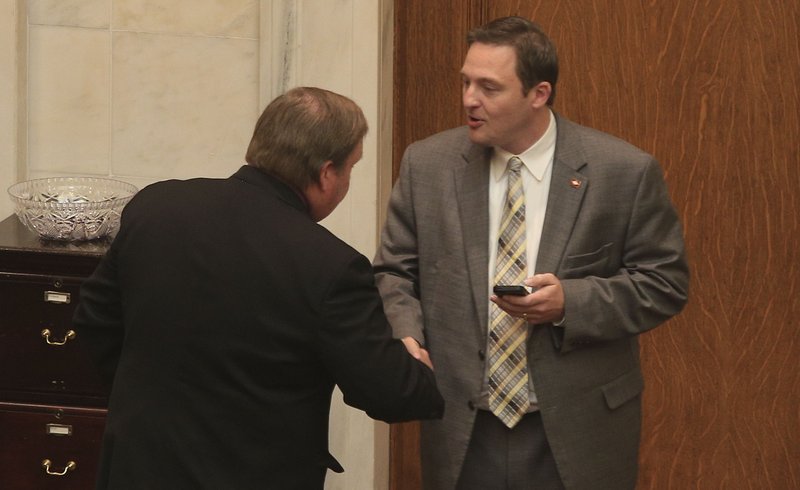 Rep. Lane Jean, R-Magnolia, (left) congratulates House Speaker Jeremy Gillam, R-Judsonia, after the House on Thursday passed the final bills for the fi scal session and adjourned.