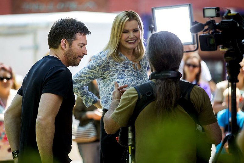 Harry Connick Jr. and Geena Davis work with a film crew Friday on the downtown square during the Bentonville Film Festival.