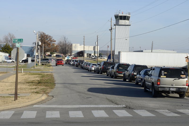 Traffic lines up Monday, Dec. 2, 2013 to pick up students from Jones Elementary School on Airport Road in Springdale. The Springdale Airport Commission is seeking an FAA grant to relocate the access road to the Terminal. Airport road becomes partially blocked when Jones Elementary starts classes and gets out.