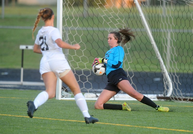 Gabby Miller, Bentonville goalkeeper, makes a play on the ball Friday during their game against Bentonville.