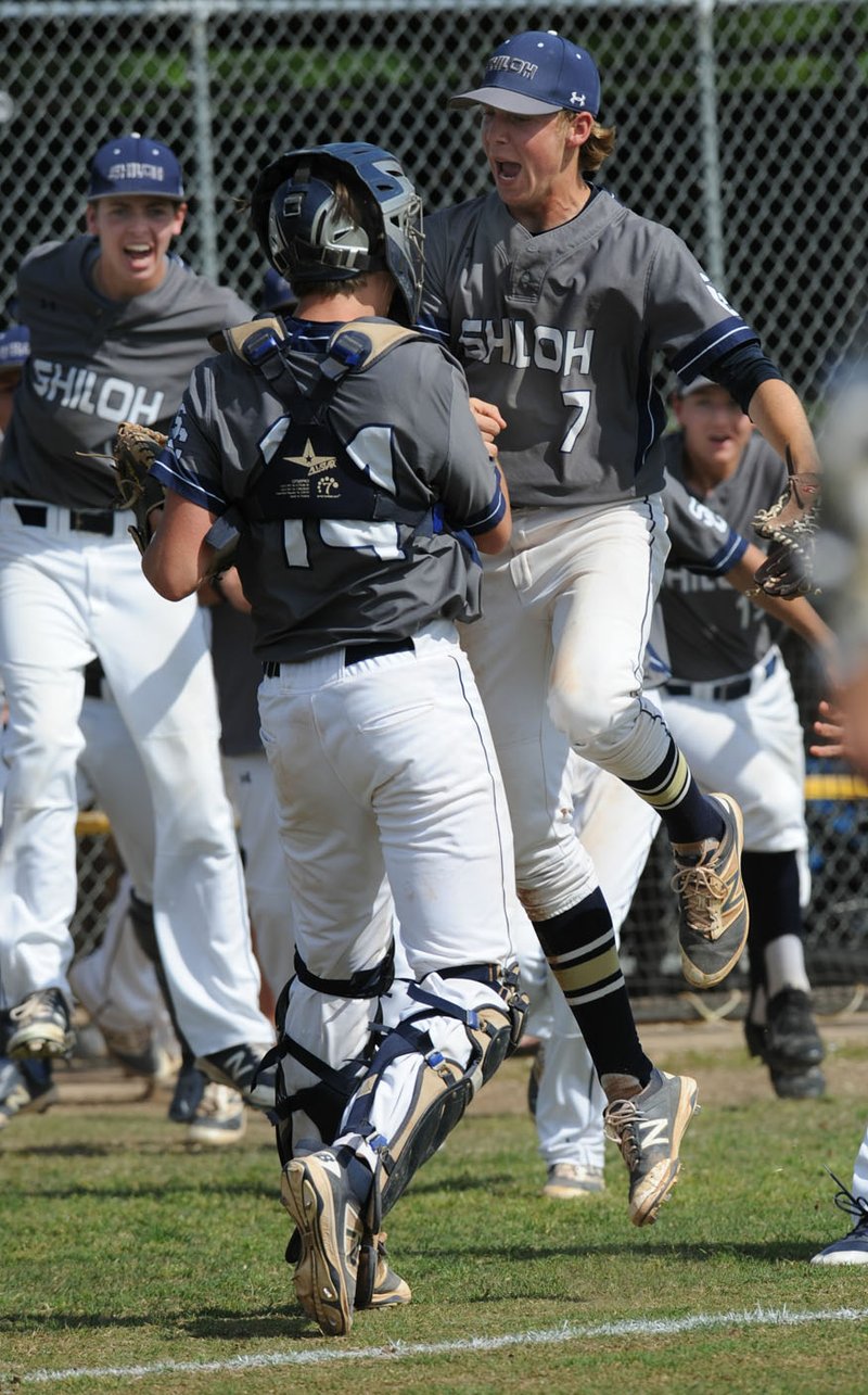 Shiloh Christian relief pitcher Josh Lantzsch (right) and catcher Broderick Butler celebrate their 4-3 win Saturday over Clinton during the 4A North Regional Baseball Tournament at Tiger Field in Prairie Grove. Visit nwadg.com/photos to see more photographs from the game.