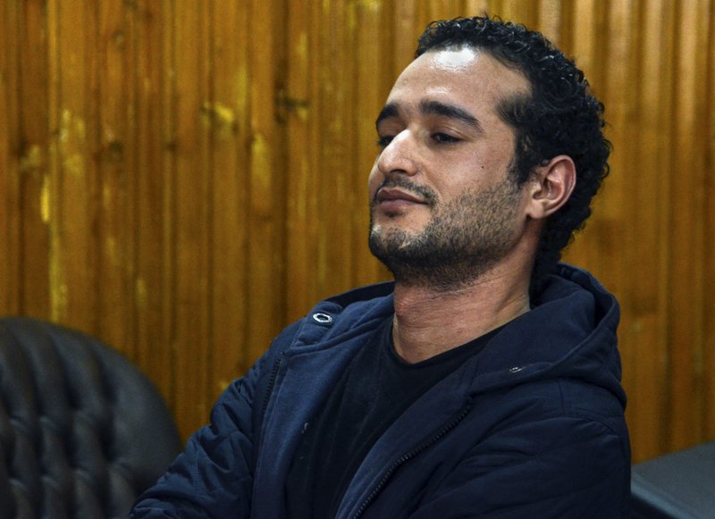 In this Wednesday, Feb. 4, 2015, file photo Ahmed Douma, one of the leading activists behind Egypt's 2011 uprising, attends a court hearing in a case against 230 people including Douma, for taking part in clashes between protesters and security forces, in a courtroom of Torah prison, Cairo, Egypt. 