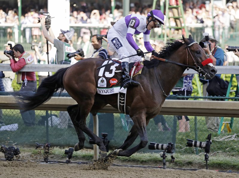 Mario Gutierrez celebrates after riding Nyquist to victory during the 142nd running of the Kentucky Derby horse race at Churchill Downs Saturday, May 7, 2016, in Louisville, Ky. (AP Photo/Garry Jones)