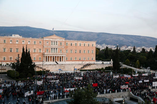 Protesters take part in an anti-austerity rally in front of the parliament in Athens, Greece, on Sunday, May 8, 2016. Other protesters hurled firebombs and other projectiles at police in front of parliament before a controversial vote on an austerity bill. 