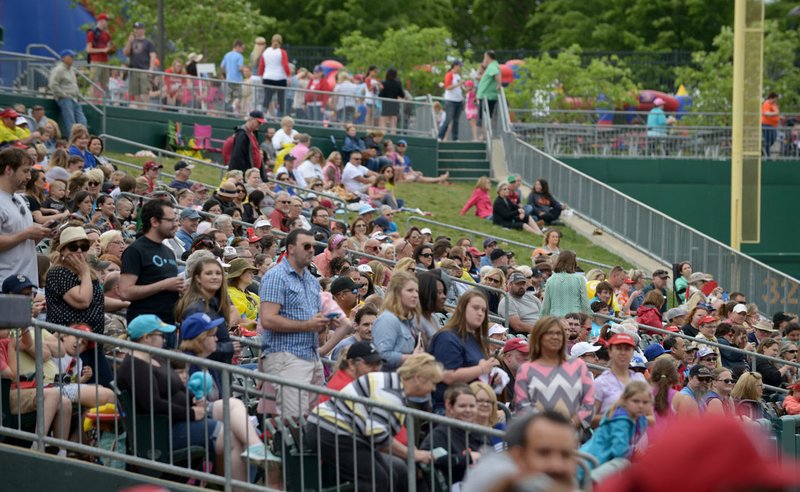 Fans watch as team comprised of sponsors and celebrity guests play Sunday during the second annual Bentonville Film Festival A League of Their Own reunion softball game at Arvest Ballpark in Springdale.