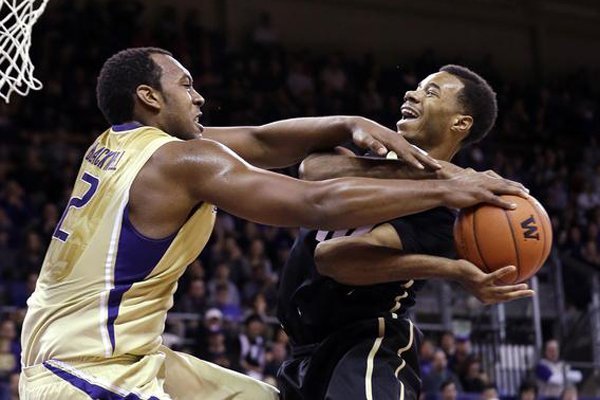 Washington's Perris Blackwell fouls Colorado's Tre'Shaun Fletcher in the first half of an NCAA men's basketball game Sunday, Jan. 12, 2014, in Seattle. (Associated Press file)