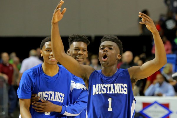 Forrest City MVP Robert Glasper (1) pumps up the crowd after defeating Maumelle in overtime during their 5A State Championship Basketball game Saturday, March 12, 2016, in Hot Springs, Ark.