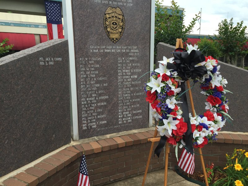 A wreath was placed Monday in front of a statue with the names of the 23 Little Rock police officers who have been killed in the line of duty. Police held an annual event for family members of fallen officers at department headquarters. 