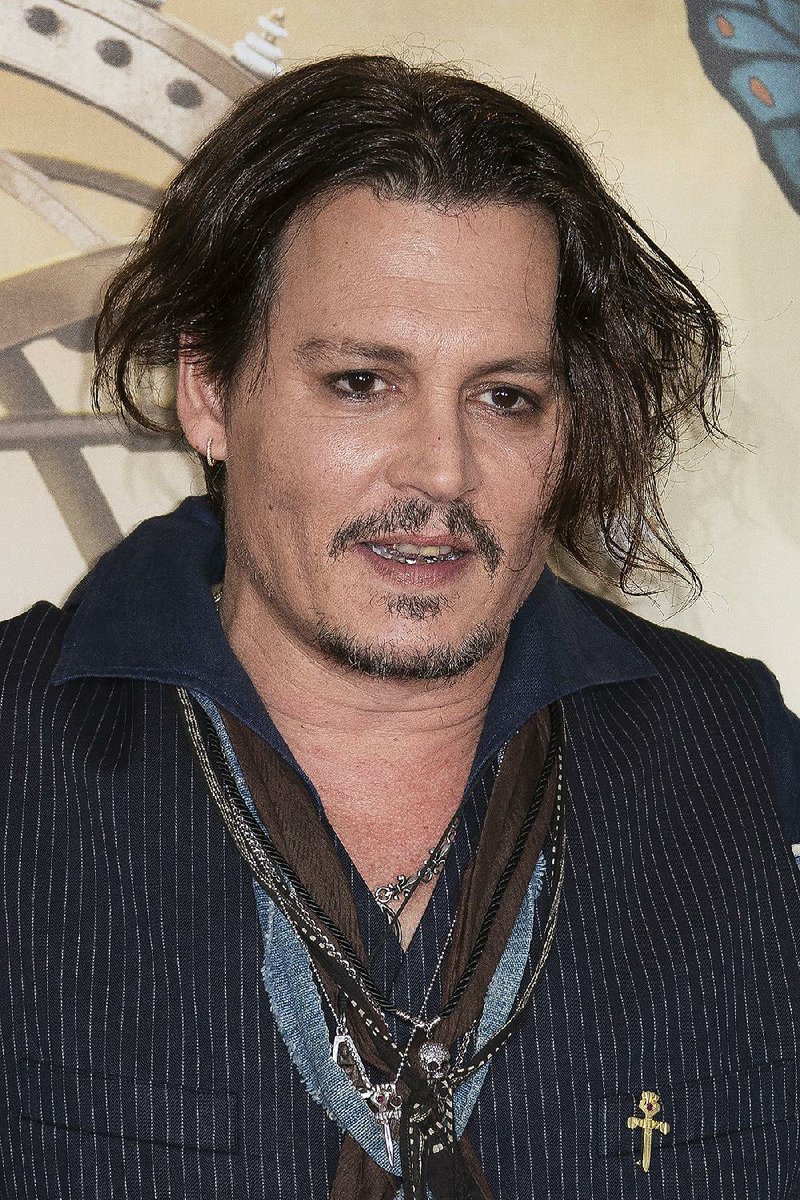 Actor Johnny Depp poses for photographers at the photo call of Alice Through The Looking Glass, at a central London hotel, Sunday, May 8, 2016. 
