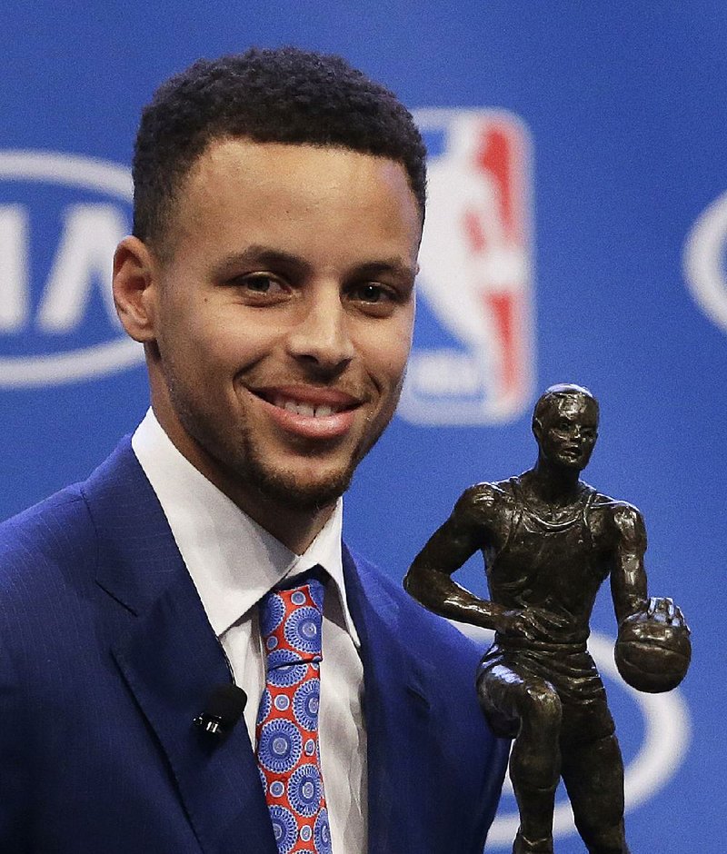 Golden State Warriors guard Stephen Curry is presented with the NBA's Most Valuable Player award Tuesday, May 10, 2016, in Oakland, Calif. Curry is the first unanimous NBA MVP, earning the award for the second straight season. 