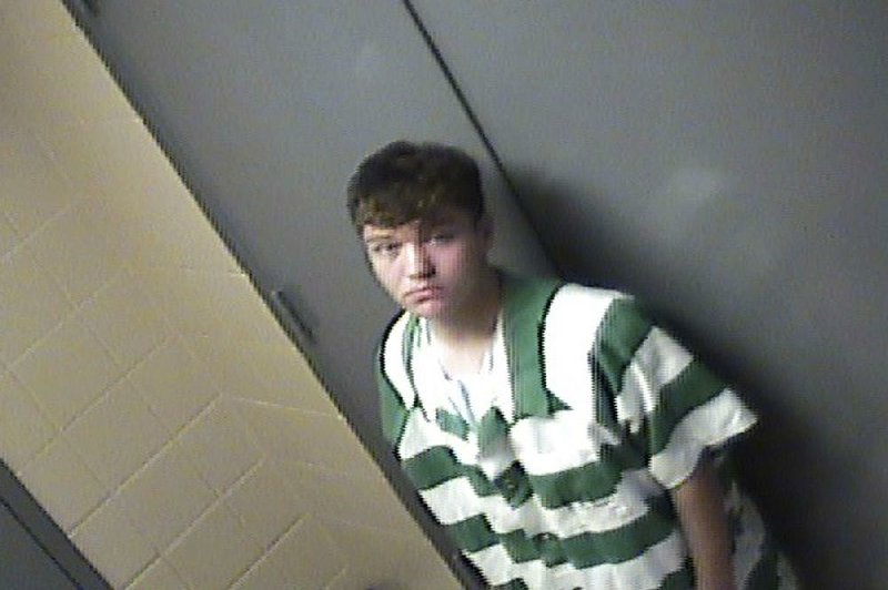 In this jail photo provided by Conway, Ark., Police Department, suspect Justin Staton stands by a door in Little Rock, Friday, Aug. 7, 2015. 
