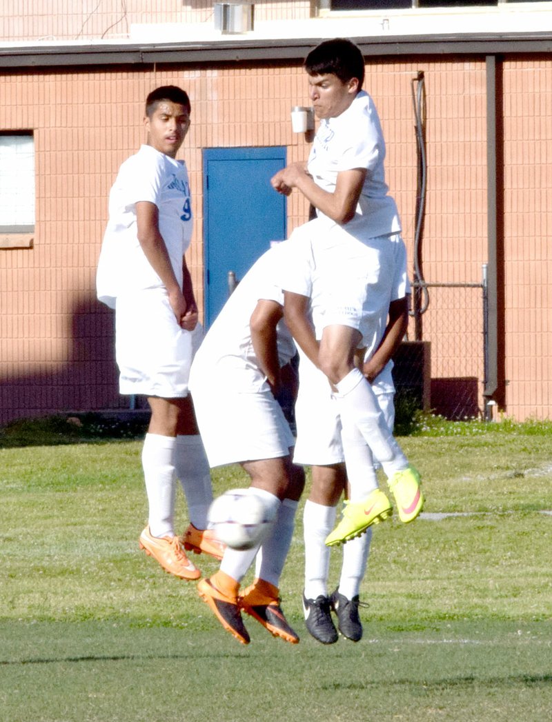 Photo by Mike Eckels Jimmy Mendoza (left), Luis Ocampo, Jafett Puga and Rigo Rubi (back behind Puga) form a wall in an effort to deflect the ball away from the net. The Decatur Bulldogs played their final home game of the season against the Prairie Grove Tigers at Bulldog Stadium in Decatur May 3.