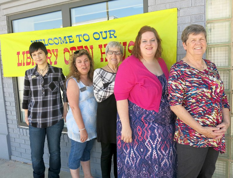 Photo by Susan Holland Kim Schneider, manager of Gravette Public Library, second from left, posed with library staff members Artemis Edmisten, Wanda Schneider, Michelle Nguyen and Sylvia Argetsinger Saturday after a busy day of greeting guests at the library&#8217;s open house. Several new library patrons were signed up at the event.