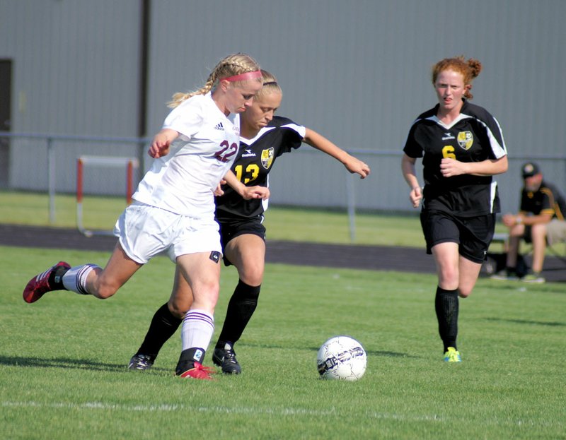 Photo by Randy Moll Amber Ellis, Gentry junior, maneuvers the ball past Prairie Grove defenders during the final game of conference play on Friday at Gentry High School. Ellis had a number of gaols and assists in the game.