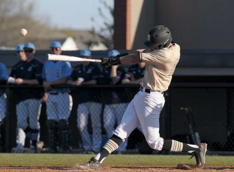 Matt Bratspies, Bentonville catcher, hits a double against Springdale Har-Ber on March 28 during the game at Bentonville’s Tiger Athletic Complex.