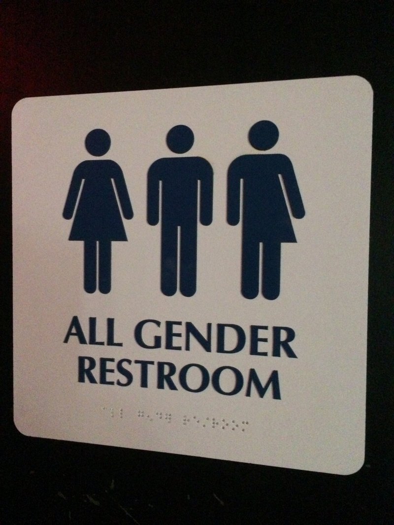 This May 11, 2014 photo shows an ";All Gender Restroom" sign outside a bathroom in a bar in Washington. Confrontations have flared across the country over whether to protect or curtail the right of transgender people to use public restrooms in accordance with their gender identity.