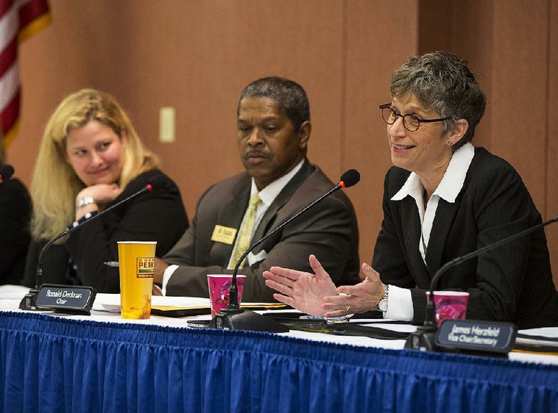 Pulaski Tech board of trustees member Emily Jordan Cox (left) and board Chairman Ronald Dedman join Pulaski Tech President Margaret Ellibee at a meeting Wednesday in which the trustees voted unanimously to merge with the University of Arkansas System. 